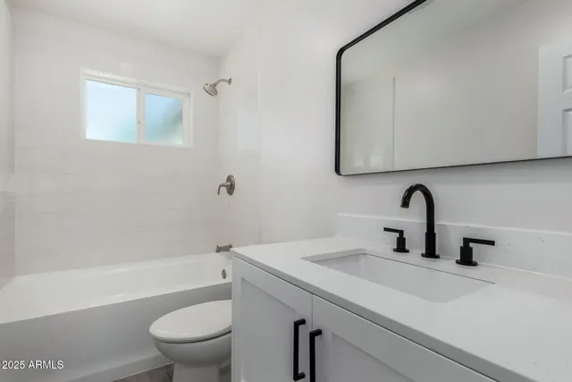 a bathroom with a sink a toilet and a bathtub