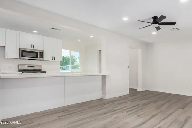 a view of a kitchen with a sink and a window