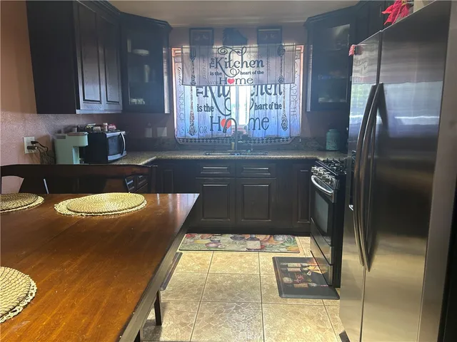 a kitchen with a refrigerator and a sink