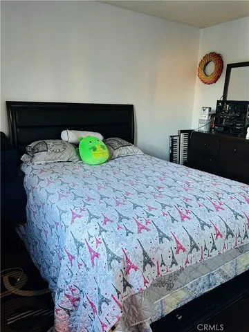 a bedroom with a bed and dresser