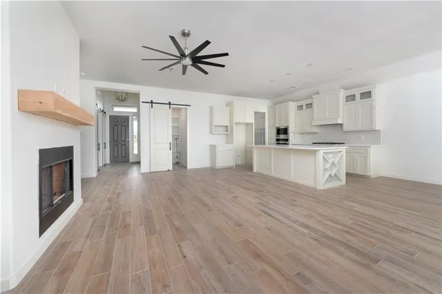 a view of a kitchen with a sink stove cabinets and empty room