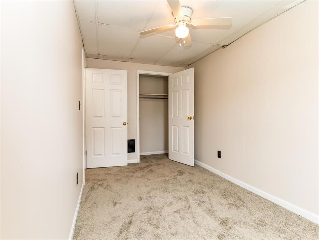 448 Park Street Rochester, PA 15074 - Photo 24 of 29 an empty room with a ceiling fan and a window