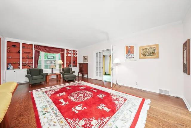 a living room with furniture rug and window
