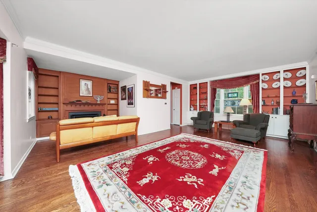 a living room with furniture rug and wooden floor