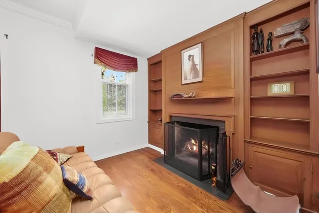 a bedroom with a fireplace and a ceiling fan