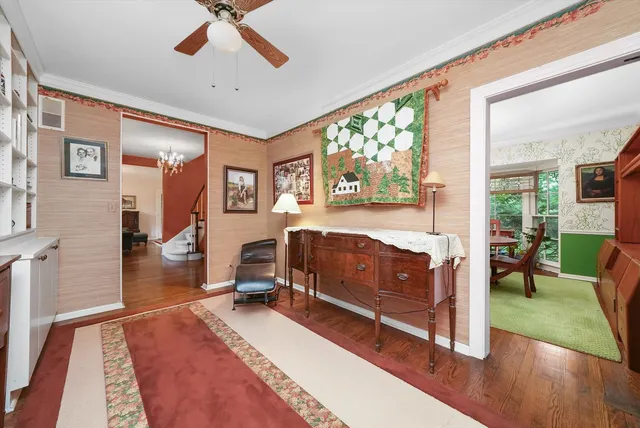 a bedroom with a bed and large windows