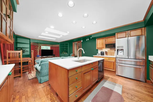 a kitchen with kitchen island a stove a sink and a refrigerator