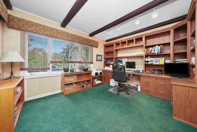 a room with furniture a rug toys and a large window