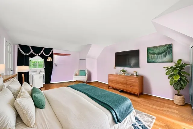 a bedroom with a bed and a flat screen tv