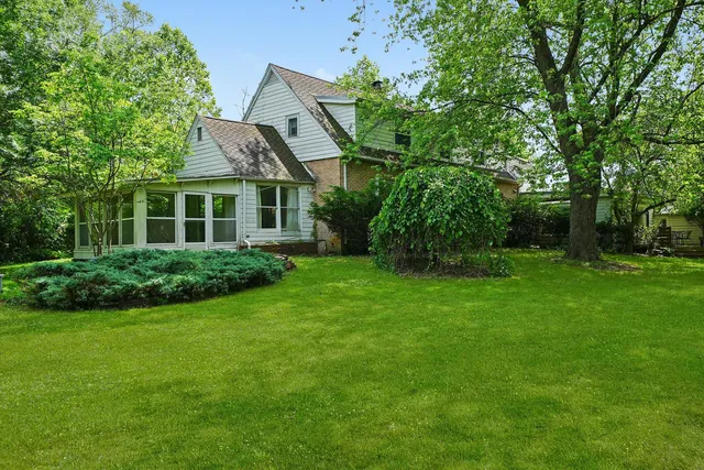 a front view of house with a garden