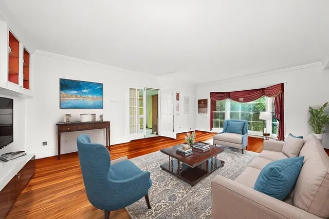 a living room with furniture fireplace and a large window