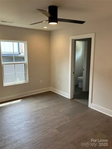 an empty room with a empty space and windows