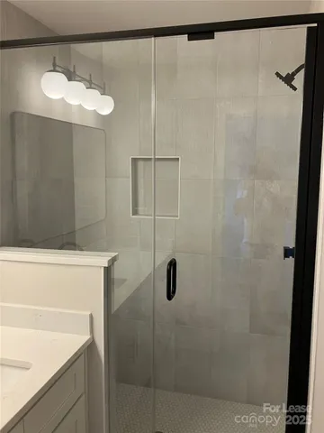 a bathroom with a shower and a sink