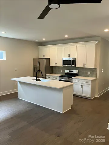 a view of kitchen with counter top space cabinets and appliances