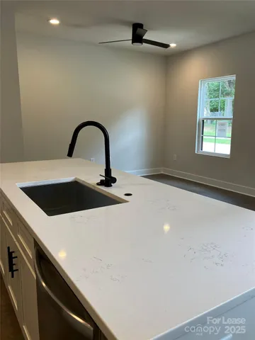 a close view of a sink a faucet and appliance in the kitchen