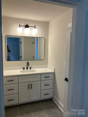 a bathroom with a double vanity sink and mirror