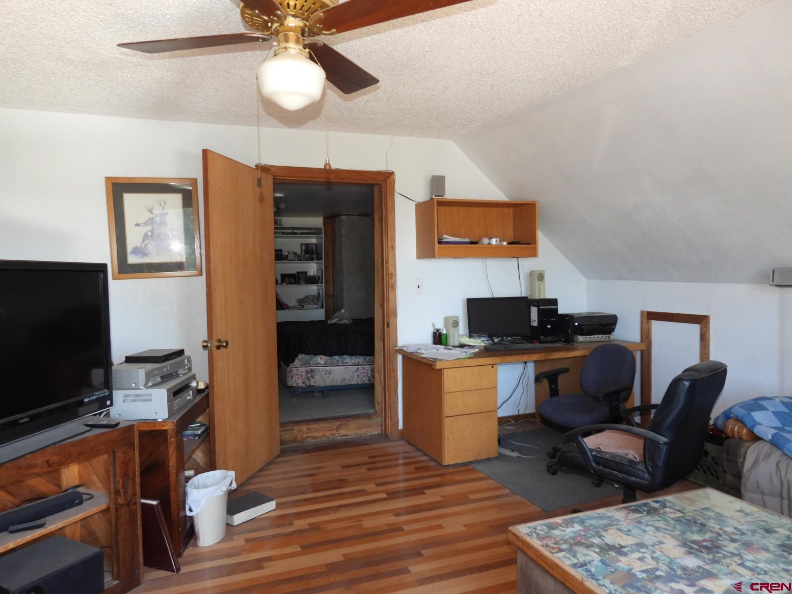 21764 R Road Cedaredge, CO 81413 - Photo 11 of 27 a living room with furniture and a flat screen tv