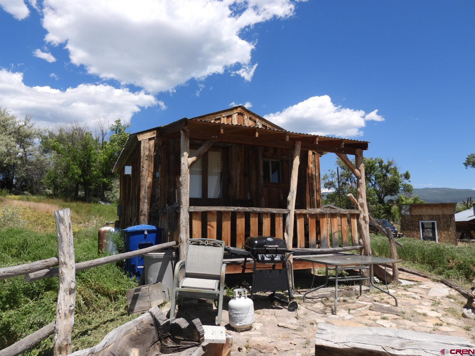 21764 R Road Cedaredge, CO 81413 - Photo 12 of 27 a front view of a house with garden and patio