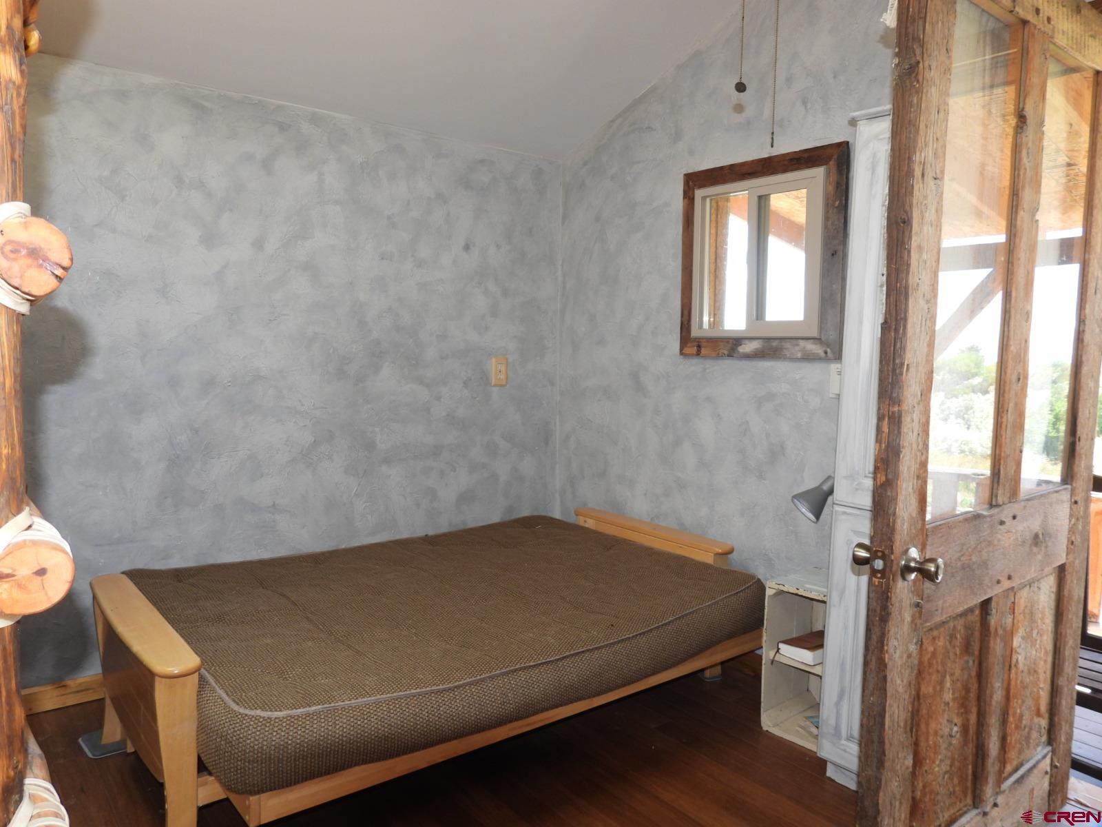 21764 R Road Cedaredge, CO 81413 - Photo 14 of 27 a room with a bed and a window