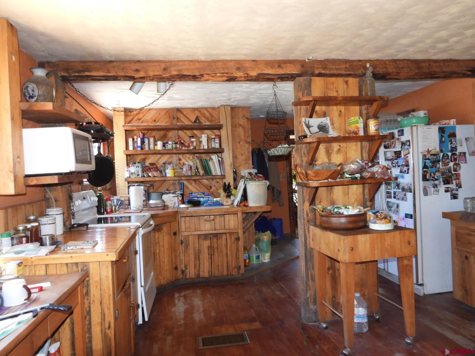 21764 R Road Cedaredge, CO 81413 - Photo 2 of 27 a picture of a dining room with furniture and wooden floor