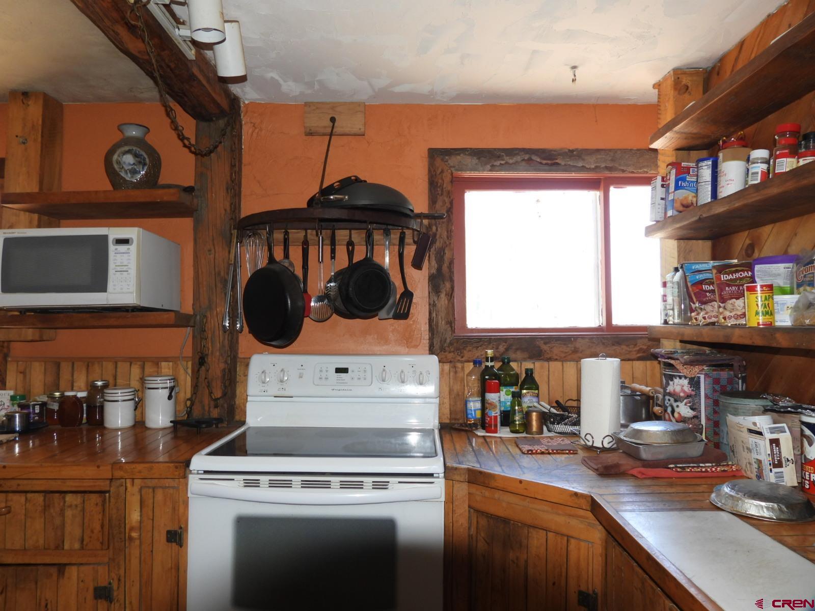21764 R Road Cedaredge, CO 81413 - Photo 4 of 27 a kitchen with a stove and a white cabinets
