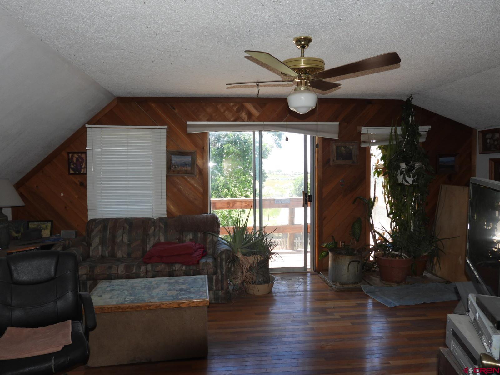 21764 R Road Cedaredge, CO 81413 - Photo 8 of 27 a living room with furniture and a large window