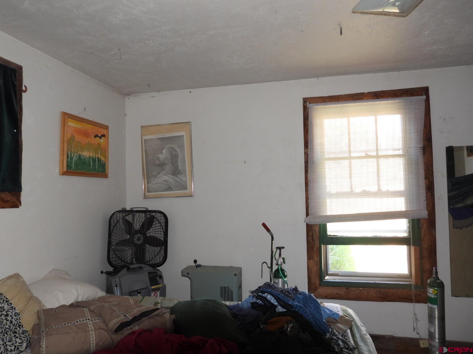 21764 R Road Cedaredge, CO 81413 - Photo 9 of 27 a bedroom with bed and a window