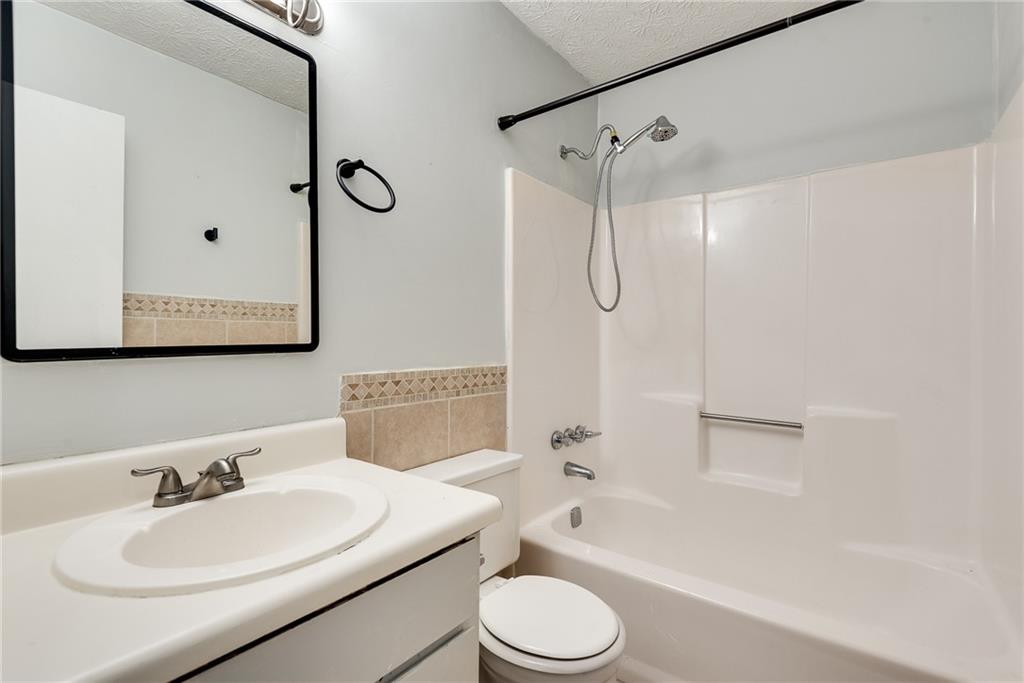 5611 Whittondale Road Lithonia, GA 30058 - Photo 23 of 34 a bathroom with a sink toilet tub and shower