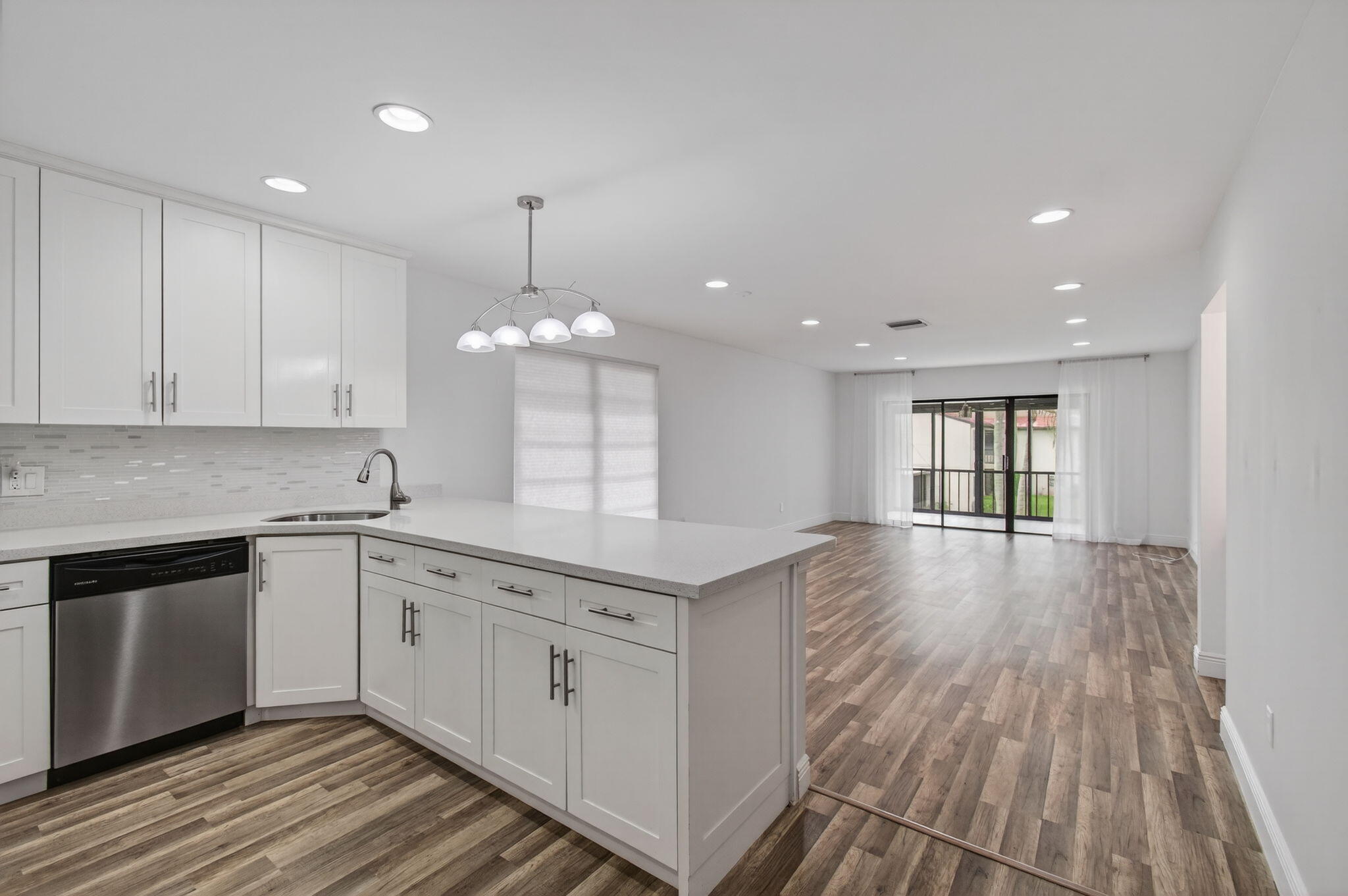 8536 Casa Del Lago, Unit 49B Boca Raton, FL 33433 - Photo 6 of 79 a kitchen with stainless steel appliances granite countertop a sink cabinets and wooden floor
