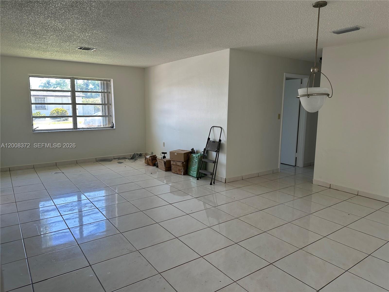 3100 Southwest 103rd Court Miami, FL 33165 - Photo 4 of 8 a view of an empty room with a window