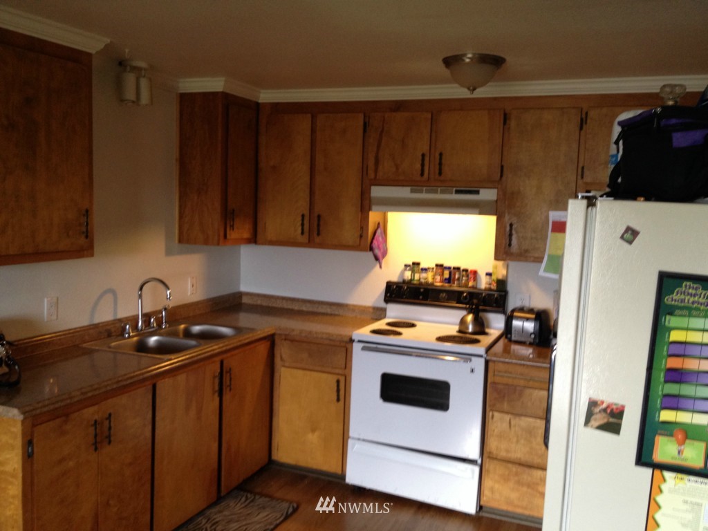 1071 Woodcock Road Sequim, WA 98382 - Photo 2 of 10 a kitchen with stainless steel appliances a stove a microwave and a sink