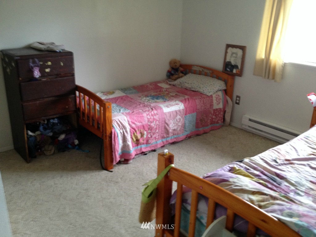 1071 Woodcock Road Sequim, WA 98382 - Photo 6 of 10 a bed sitting in a bedroom next to a window
