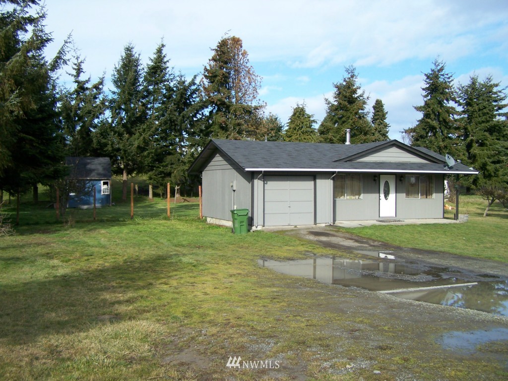 1071 Woodcock Road Sequim, WA 98382 - Photo 8 of 10 a front view of a house with a yard