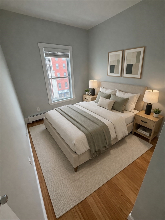83 Chelsea Street, Unit 3 Boston, MA 02128 - Photo 4 of 8 a bedroom with a bed and a window