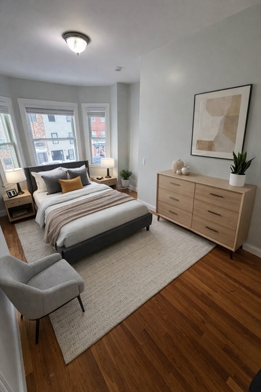 83 Chelsea Street, Unit 3 Boston, MA 02128 - Photo 5 of 8 a bedroom with a bed and window