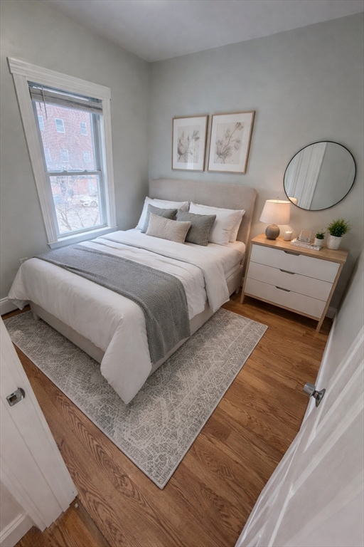 83 Chelsea Street, Unit 3 Boston, MA 02128 - Photo 6 of 8 a bedroom with a bed and window