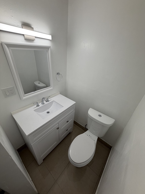 83 Chelsea Street, Unit 3 Boston, MA 02128 - Photo 8 of 8 a bathroom with a toilet sink and mirror