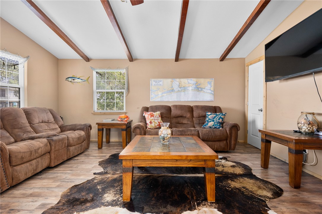 108 Palmetto Point Road Rockport, TX 78382 - Photo 12 of 22 a living room with furniture a table and wooden floor