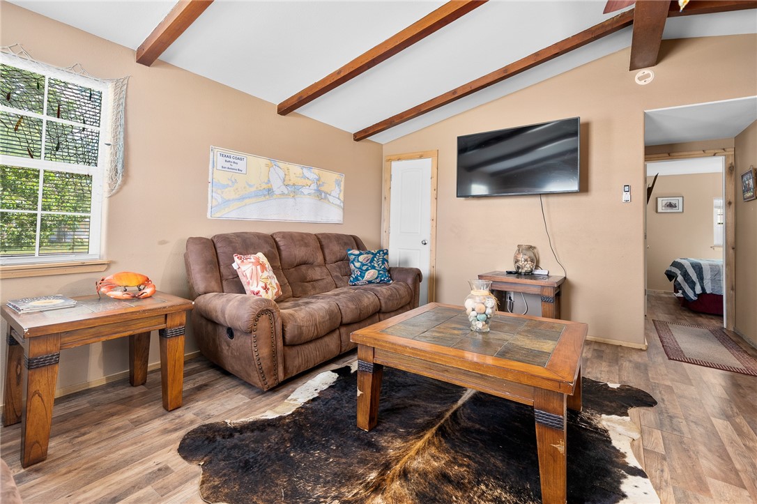 108 Palmetto Point Road Rockport, TX 78382 - Photo 14 of 22 a living room with furniture a flat screen tv and kitchen view
