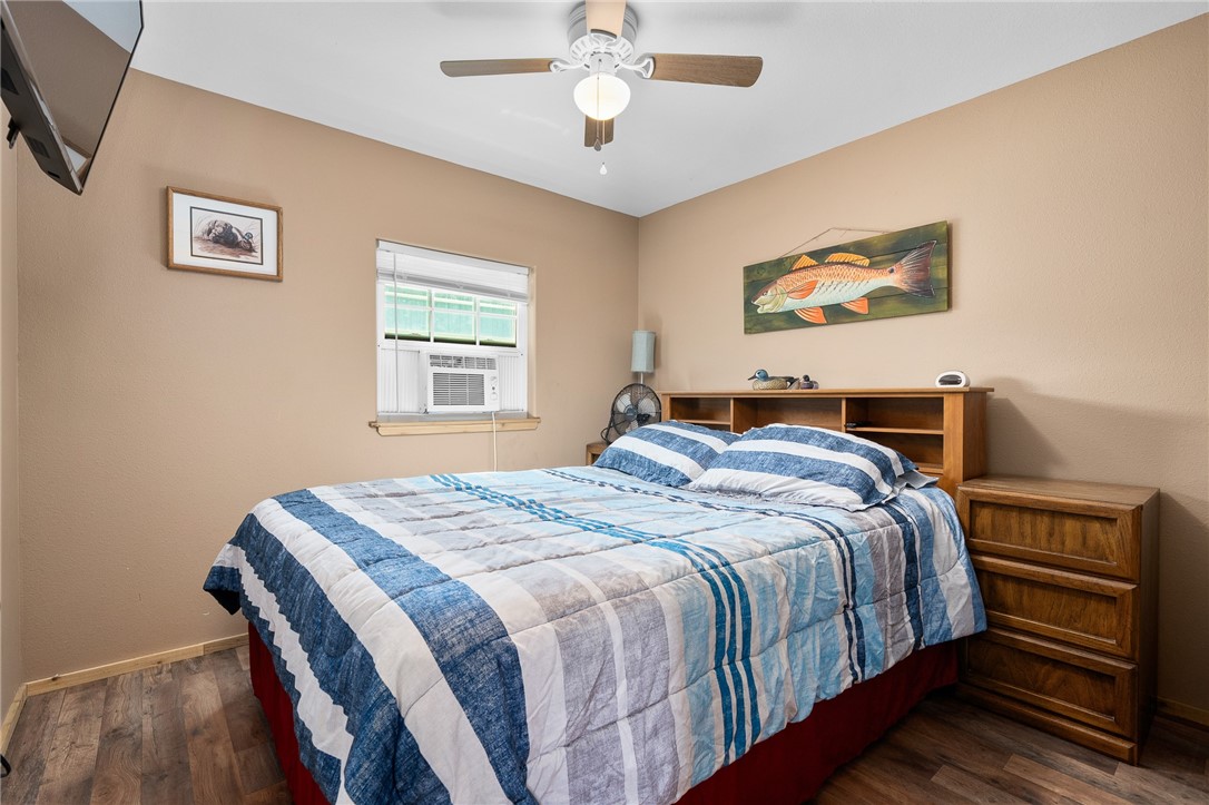 108 Palmetto Point Road Rockport, TX 78382 - Photo 17 of 22 a bedroom with bed and wooden floor
