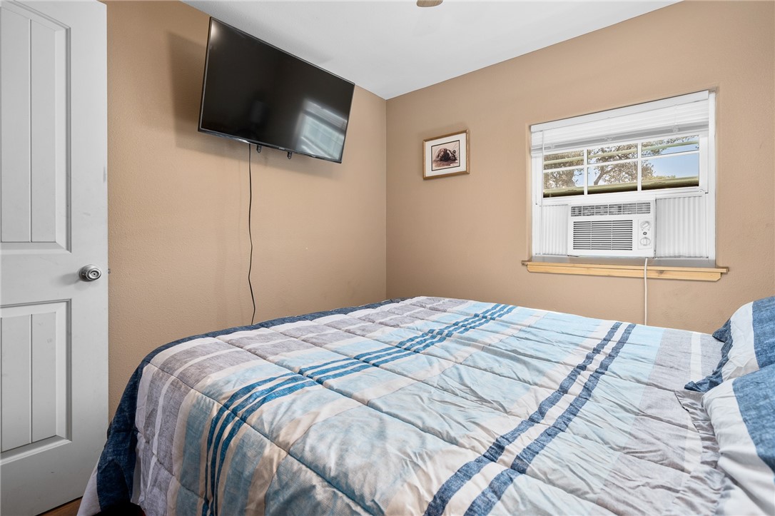 108 Palmetto Point Road Rockport, TX 78382 - Photo 18 of 22 a bedroom with a bed and a flat screen tv