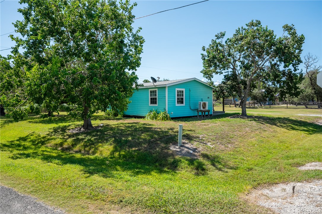 108 Palmetto Point Road Rockport, TX 78382 - Photo 2 of 22 a front view of house with yard and green space