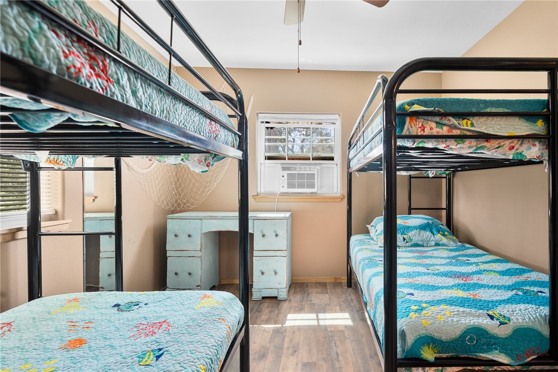 108 Palmetto Point Road Rockport, TX 78382 - Photo 22 of 22 a bedroom with a bed and a painting on the wall