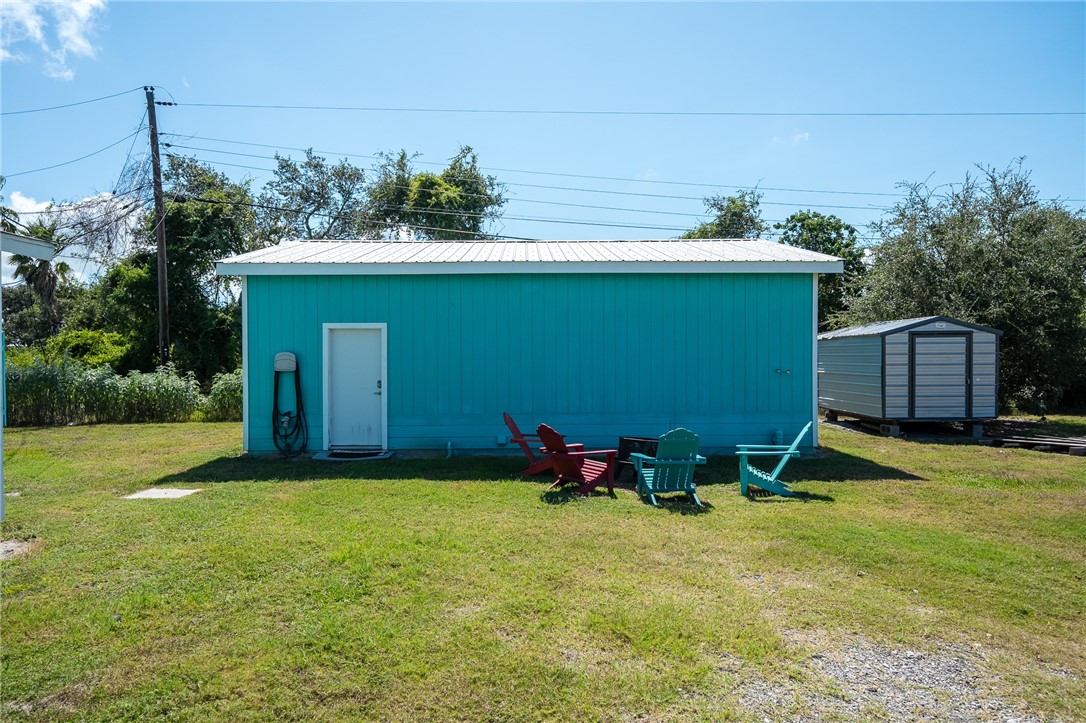 108 Palmetto Point Road Rockport, TX 78382 - Photo 5 of 22 a backyard of a house with table and chairs