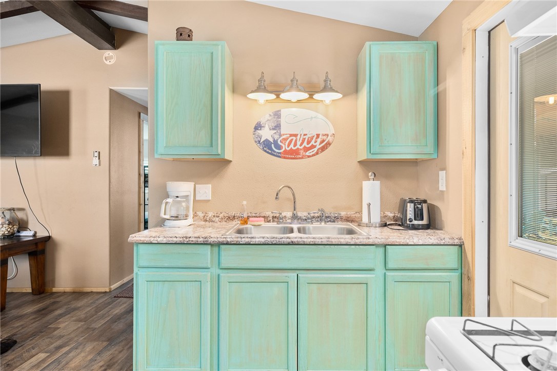 108 Palmetto Point Road Rockport, TX 78382 - Photo 8 of 22 a kitchen with a sink cabinets and wooden floor