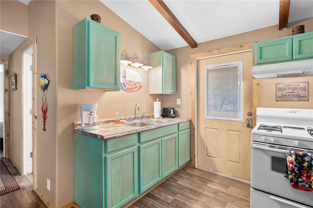 108 Palmetto Point Road Rockport, TX 78382 - Photo 10 of 22 a kitchen with a sink cabinets and wooden floor