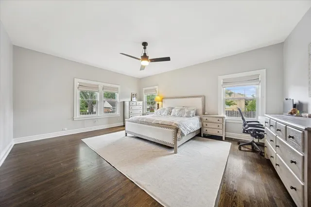 a spacious bedroom with a bed a chandelier and a window