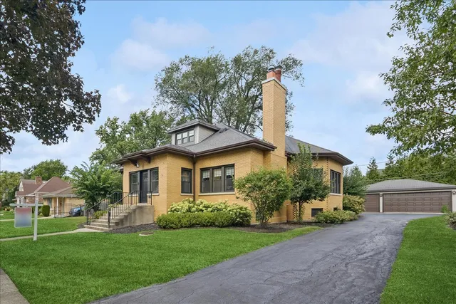 a front view of a house with a garden and plants