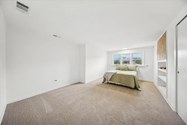 a bedroom with a bed and lamp