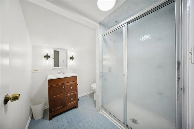 a spacious bathroom with a shower sink and mirror
